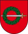 A coat of arms depicting a sword with a gold hilt and a silver blade penetrating a green wreath all on a red background