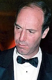 Color photo of a man in a tuxedo.