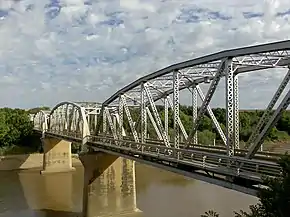 The four span through truss General Hertzog Bridge over the Orange River at Aliwal North carries vehicular traffic