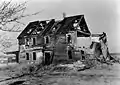 Archival photograph of the ruin of the house taken circa 1935, before it fell down entirely in 1938