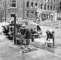 Women doing their wash at a cold water hydrant in a Berlin street, July 1945