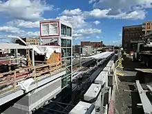 An entrance to a below-grade railway station under construction