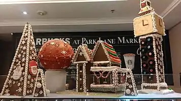 Gingerbread house and Elizabeth Tower in London, United Kingdom