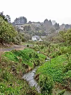 Stream, former rail track and former medical centre in 2014