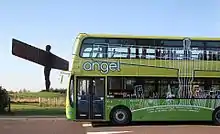 Angel of the North statue with a green Go North East Angel bus