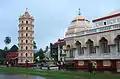 A photo showing the Gopuram, temple and Deep Stambha.