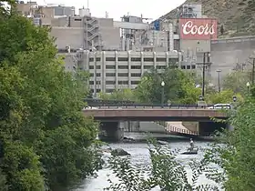 A color photograph of the Coors brewing facility in Golden, Colorado, with the Clear Creek in the foreground