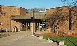 Golden Valley branch, a one-story brick building located in a grove of trees.