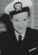 A young white woman, smiling, wearing a U.S. Navy uniform.