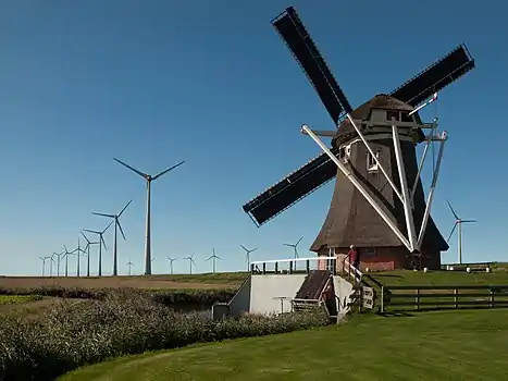 Smock mill Goliath in front of the wind farm Growind