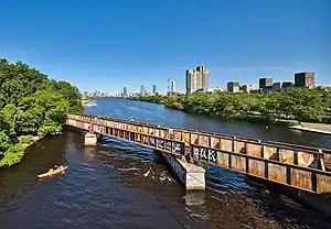 A railroad bridge crossing an urban river