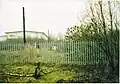 Great Bridge North railway station, walking down from the crossing and past the signal box, towards the modern warehouse in 2003. The canal bridge is fenced off and collapsing.