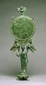 Fancy Early Classical bronze mirror with human caryatid handle, c. 460 BC