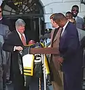 A photo of Reggie White and other Packers players with former president Bill Clinton