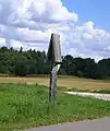 A roofed pole in Griniai, next to a road to Kupsčiai