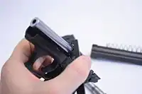 Heckler & Koch P7K3 using the exchange tool to tighten to barrel nut to install a .32 ACP barrel