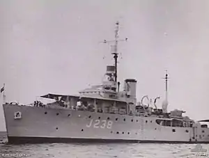 HMAS Gympie in November 1945. An awning has been fitted over the ship's bow.