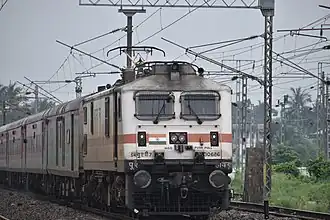 Howrah based WAP7 on lead with 02302 New Delhi - Howrah Rajdhani Express Special at Janai Road