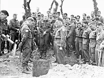 H Captain Callum Thompson, a Canadian chaplain, conducting a funeral service in the Normandy bridgehead, France, 16 July 1944