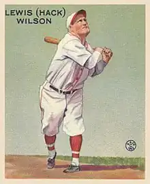 A man wearing a white baseball uniform and cap with red trim swinging a baseball bat