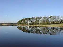 A boat house at the edge of a lake