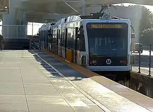 A westbound train at Harbor Freeway station