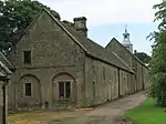 Range of outbuildings and stables, and walls enclosing a courtyard to south of Hardwick Hall