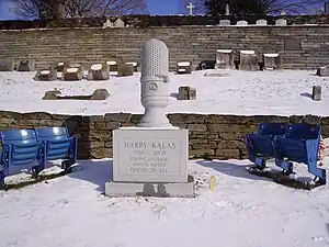 The gravesite of Harry Kalas, Philadelphia Phillies radio broadcaster, includes a microphone shaped tombstone and two pairs of seats from Veterans Stadium