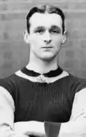 Clean-shaven white man with neatly trimmed hair in a sports jersey