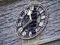 Close up of the clock, which is the War Memorial in Haselor