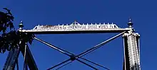 A photograph of an inscription of the names of the fabricators of the bridge, located on top of one of its entryways. It reads: "CLARKE, REEVES & Co. PHOENIXVILLE BRIDGE WORKS. Pa."