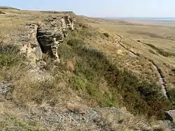 A line of rocks overlooking a plain.