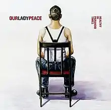 In a white room, a young man in a white shirt with suspenders sits in a chair facing away from the world. The band's name is to the left of his head while the album's name is to the right, in red.