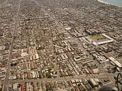 The Hellman neighborhood of Long Beach, California, seen from the air, facing southeast. Alamitos Avenue runs across the photo at the bottom, 7th Street runs from the bottom right corner to the top of the photo, and 10th Street runs from the bottom left to the top. Hellman Street cuts diagonally across the center.