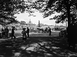 In 1910s with a rental horse-drawn carriage parked in front