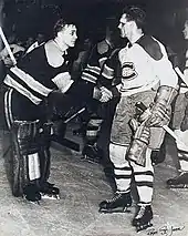 Richard, with blood on his face, shakes hands with goaltender Jim Henry, who is hunched forward in a slight bow