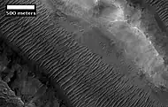 Her Desher Vallis close-up, as seen by HiRISE.  Her Desher Vallis is found in the Coprates quadrangle.