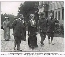 A small group of people, including the Duke and Duchess and Saxe-Coburg and Gotha, stood outside a golf club