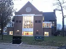 Two storey building of triangular shape around an entrance archway