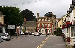 Traffic junction with Queen Anne redbrick house beyond