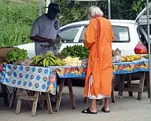 A sadhu purchasing vegetables in Debe Market