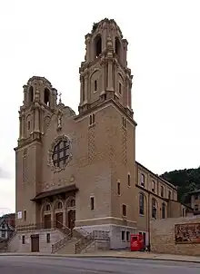 A Notre Dame style church with twin steeples and a rose window