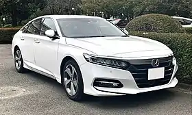 Front three-quarter view of a front-engined four-door car.