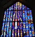 Stained glass over front door, with Jesus on a surfboard at top left