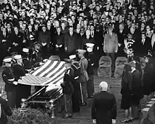 An honor guard folds the flag of the United States at Arlington National Cemetery in preparation for flag presentation to Jacqueline Kennedy on November 25, 1963.