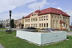 Pionýrů Square with a school and Marian column