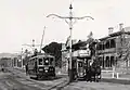 1909 : In North Terrace, a "toast rack" electric tram passes a horse tram running a service until its line was upgraded.