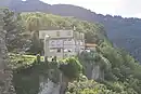 Hotel Wartenstein Castle with Jesus statue. View from the ruins of Wartenstein Castle.