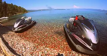 Jet-skis parked on an Eastern shore.