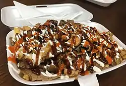 Halal snack pack, an Australian fast food dish of doner kebab meat and chips with sauces.